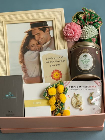 Capture your favorite memories with this Rakhi hamper. It comes with a photo frame, matching Zara perfumes for him and her, a Haldiram masala chai tin, and a beautiful lumba rakhi set.