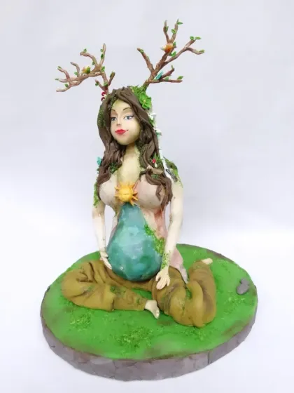 This is one of my favorite artistic creations, a fully sculpted "Mother Earth" cake. Every detail, from the antlers with tiny birds to the flowing hair and the earth-themed belly, is handcrafted from fondant, showcasing my passion for detailed sugar art.
