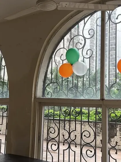 Minimalist balloon decorations in the colors of the Indian flag for an Independence Day or Republic Day celebration at a clubhouse.