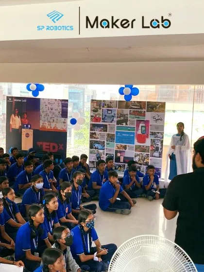 Another angle of a school visit, showing the students' rapt attention. Our goal is to make technology fascinating and accessible.