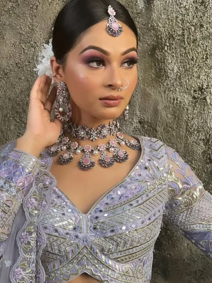 A close-up on the details of this pastel lavender lehenga. The combination of mirror work and thread embroidery, paired with modern jewelry, creates a chic and trendy look.