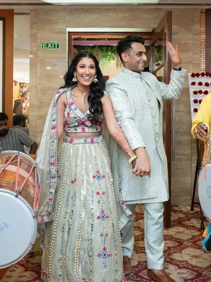 The couple making a grand entrance to their Mehendi party with dhol players.