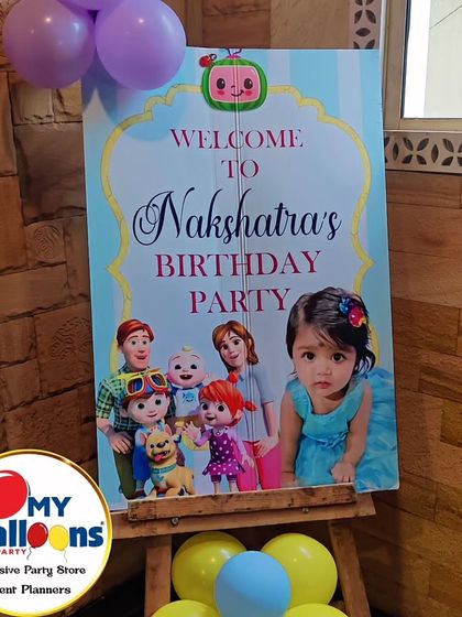 A personalized welcome sign for a Cocomelon-themed first birthday, featuring a photo of the birthday girl.