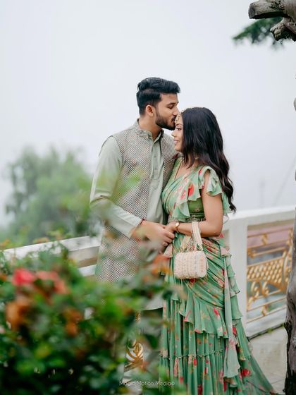 A sweet moment between the couple. The bride's soft, romantic makeup and wavy hair are perfect for this outdoor pre-wedding event.