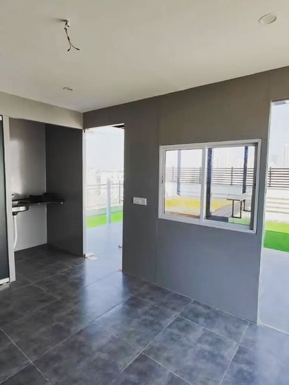 The interior of our modern ACP-paneled room, showing the finished walls and flooring. The large windows and doors are designed to maximize views and natural light.