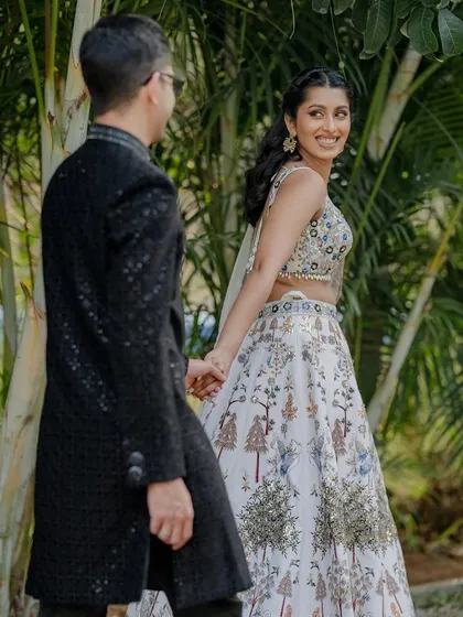 A candid shot of a couple during their cocktail celebration. The natural greenery provides a beautiful, soft background for this happy moment.
