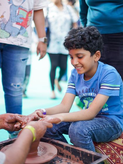 Getting hands-on with a pottery wheel. This sensory activity is always a huge hit, allowing kids to feel the clay and create their own small pots with guidance.
