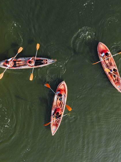 An aesthetic top-down view of three kayaks, showcasing the beauty and tranquility of our lake activities.