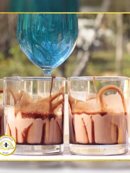 A decadent chocolate shake being poured from a blue goblet. We create delicious non-alcoholic options that are just as visually stunning and creative as our cocktails.