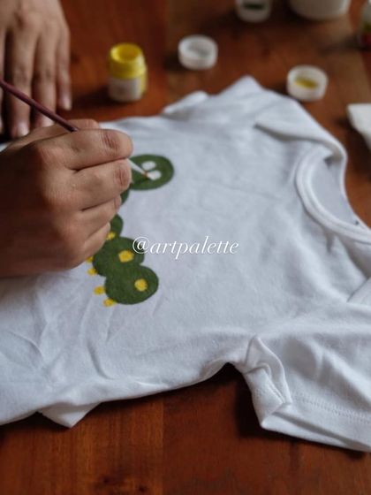 Adding the final touches to a cute caterpillar design. We use high quality, baby safe fabric paints to ensure every creation is ready for the little one to wear.