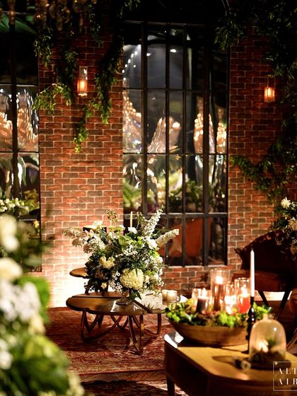 A lounge corner at the glass house reception, where vintage mirrors reflect the warm, candlelit ambiance. The design was about creating a space that feels like it has a story to tell.