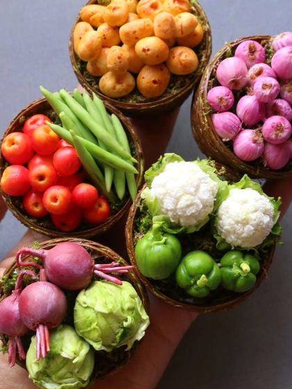 A handful of my miniature vegetable baskets, including tomatoes, beans, and cauliflower.