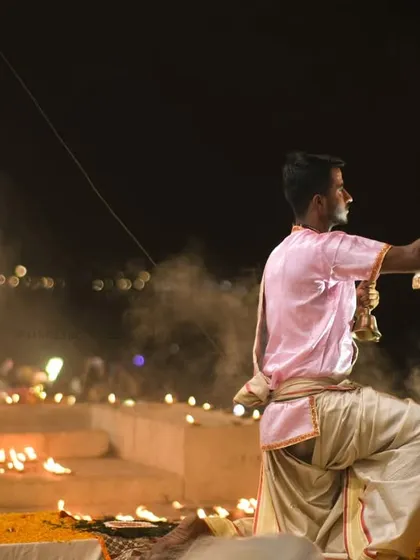 A wide-angle view of the Ganga Aarti, showing multiple priests performing the ritual in unison. This highlights the scale and coordination of the grand ceremony.