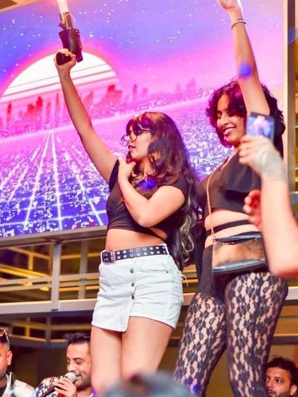 The crowd taking over the stage during a high-energy moment. My sets are designed to make everyone feel like a part of the show.