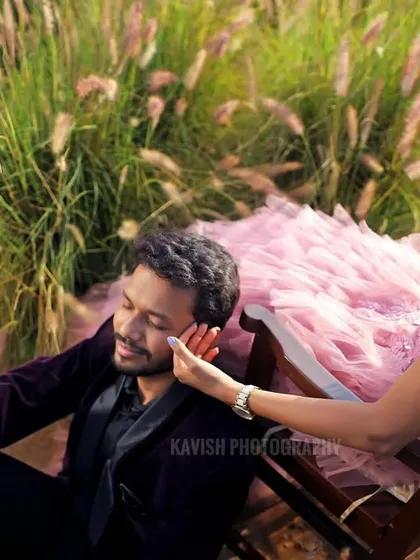 A close-up shot capturing a gentle touch and a quiet moment between the couple during their outdoor pre-wedding session.