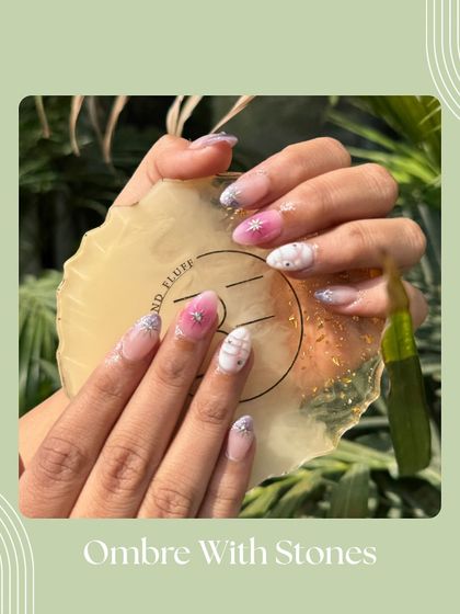 Ombré with stones is a perfect way to add some glam. This design features a pink and white gradient with a cascade of tiny iridescent stones near the cuticle.