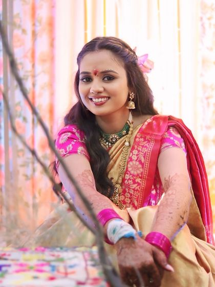 A smiling portrait of the bride at her Ganesh Poojan, looking absolutely radiant.