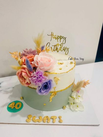 Blooming into the fabulous 40s with style and grace. A two-tone cake with a cascade of fresh flowers.