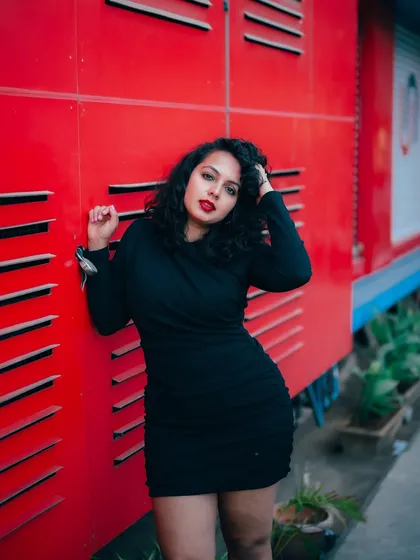 I use bold colors and strong compositions to make fashion portraits pop. This shot against a vivid red wall in Bangalore shows how an urban environment can become a dynamic studio for creating high-impact images.