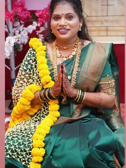 A client wearing a traditional 'Tagar Shela' with a marigold border for her ceremony. It drapes beautifully over the shoulders.