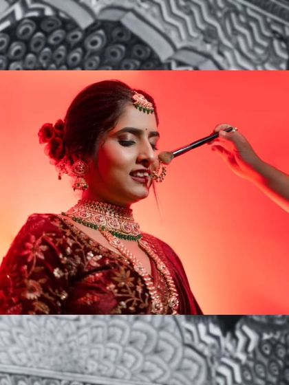 A behind-the-scenes shot of the makeup artist giving the final touches to the bride. This captures the process and anticipation of getting ready.