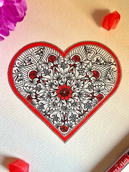 A piece of love, just for you. This heart-shaped mandala is filled with intricate floral patterns in red and black, making it a perfect piece to celebrate love and connection.