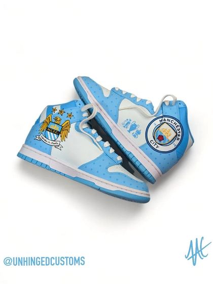 A full view of the inner sides of the Man City custom dunks, showing both the old and new club crests.