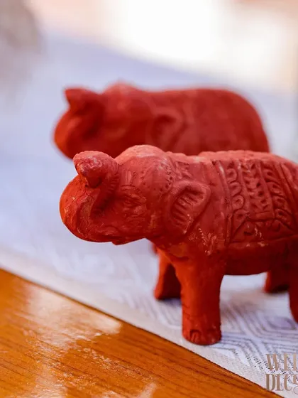 Tiny, hand-carved terracotta elephants used as decorative accents on the tables. These small, thoughtful details are what make a theme truly come alive.