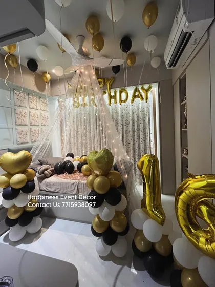 For a more modern and elegant look, I offer canopy setups in different color schemes. This 16th birthday decoration uses a black, gold, and white palette with balloon pillars and a fairy light tent.