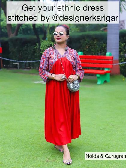 A client looking chic in a red ethnic dress with a printed yoke. Get your custom ethnic dresses stitched by us in Noida and Gurugram.