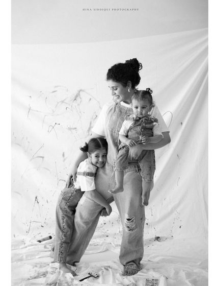 A classic black and white portrait that feels both timeless and full of life. The gentle smiles and relaxed poses show a family completely at ease with each other.