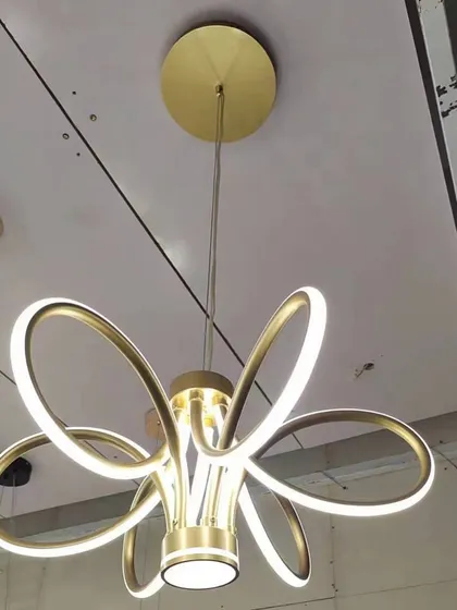 A modern floral-inspired chandelier with sleek, curved LED petals. This design offers a contemporary take on a classic chandelier form, perfect for modern homes.