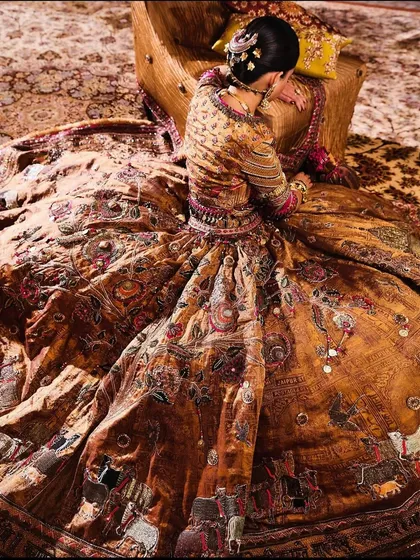 This richly detailed, earth-toned ensemble from Delhi Vintage Co. is a masterpiece of texture and artistry. The intricate embroidery tells a story, making it a true statement piece.