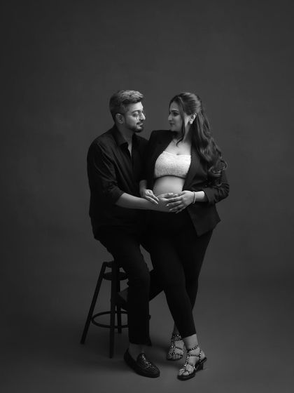 Modern, chic, and confident. This black and white portrait with a blazer and exposed bump is for the mom who wants to celebrate her pregnancy with a touch of high-fashion style.