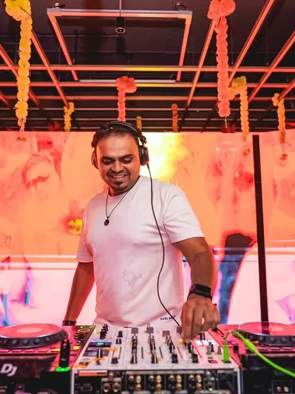 A happy moment at the console, with colorful visuals lighting up the screen behind me. A good VJ setup makes every photo look incredible.