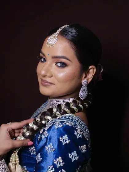 The model shows off her complete look, including the intricate hairstyle and diamond jewelry.