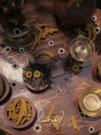 A stunning sunflower-themed Haldi decor with traditional elements like turmeric and brass bowls, created with a Western twist.