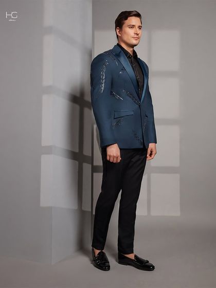 A full-length profile of the blue cocktail jacket, demonstrating its slim, modern fit and how it creates a sophisticated silhouette for any evening event.