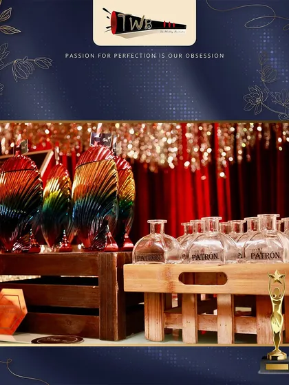 A display of premium Patron tequila and unique rainbow-colored glassware at an awards night.