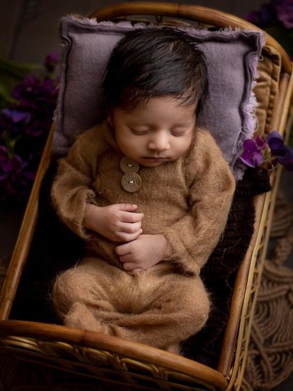 So cozy and snug in this knitted brown outfit. This pose in a miniature bed shows how I ensure babies are always comfortable and safely positioned during their studio session.