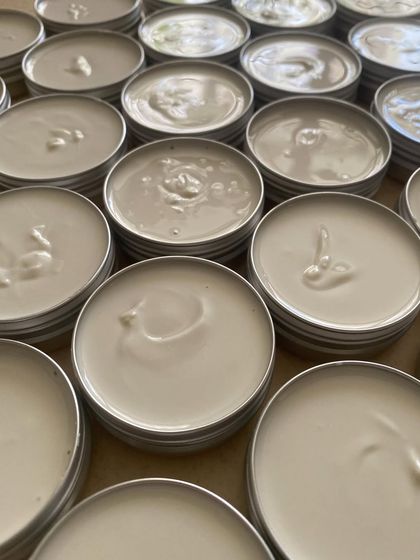 Freshly poured deodorant creams and lip balms in their reusable tin containers. Sustainability starts with small steps, and choosing reusable packaging is one of them.