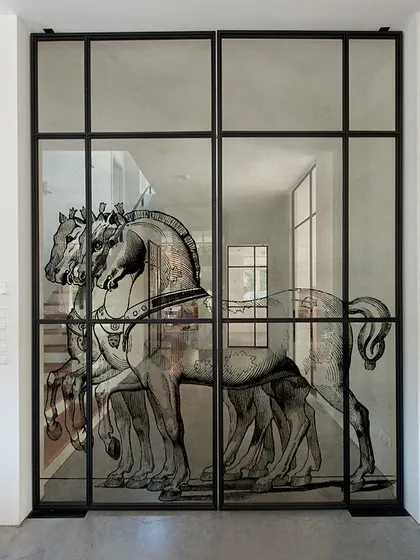 A set of glass doors becomes a canvas for this stunning, minimalist horse illustration. The printed design adds an element of artistry and grandeur to the space while maintaining a sense of openness and light.