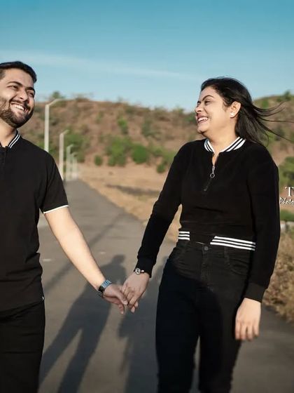 A simple, happy moment of the couple walking hand-in-hand down a quiet mountain road. Sometimes the most beautiful shots are the most natural ones, capturing the joy of just being together.