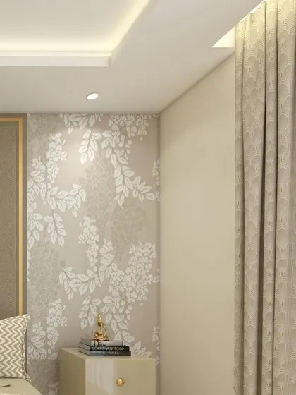 A detail shot of a master bedroom, showing a floral wallpapered accent wall next to the bed. A small Buddha statue on the nightstand adds a touch of serenity to the elegant space.