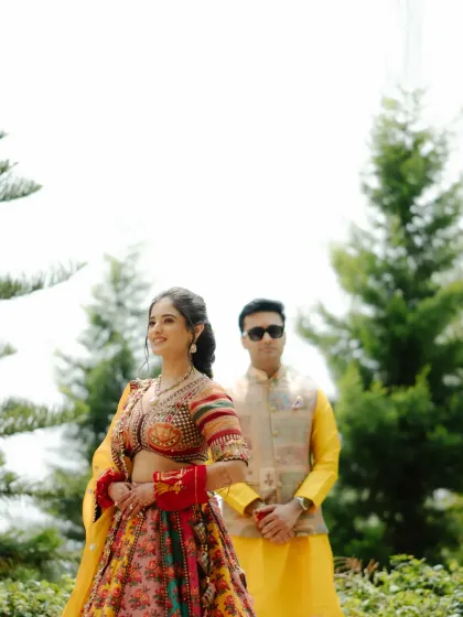 A stylish portrait of the couple during their Haldi. The bride looks radiant while the groom stands coolly behind her, creating a lovely dynamic.