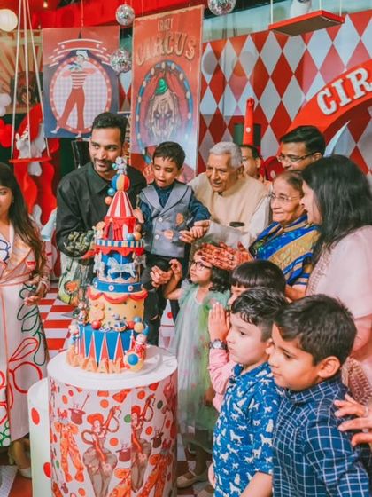 The cake cutting ceremony is a highlight of any birthday. Here, Avyaan is surrounded by his family and friends, creating a cherished memory against the backdrop of his spectacular circus party.