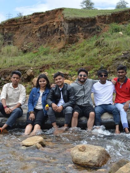 The whole gang sitting on a log across the stream. It's a great photo that captures the spirit of our group.