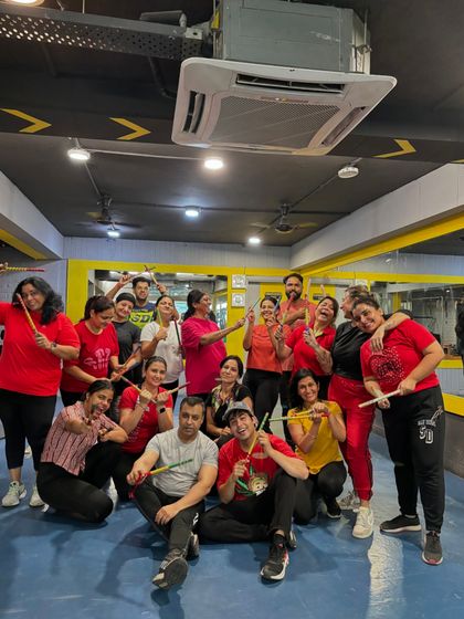 The entire fam posing with dandiya sticks after our Navratri 2024 session.