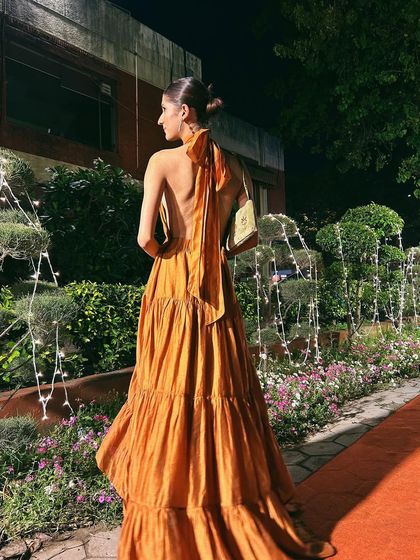 The full backless view of the halter dress. It's a statement piece that is both sophisticated and daring.