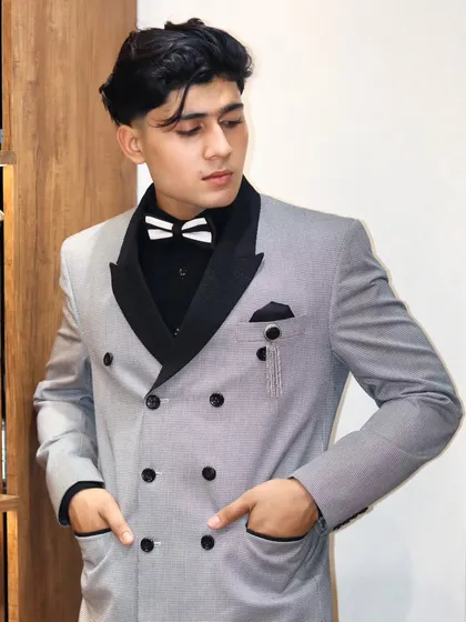 A modern take on the classic double breasted suit. I designed this with a pinstripe fabric and contrasting black lapels, creating a bold and stylish look for any formal celebration.